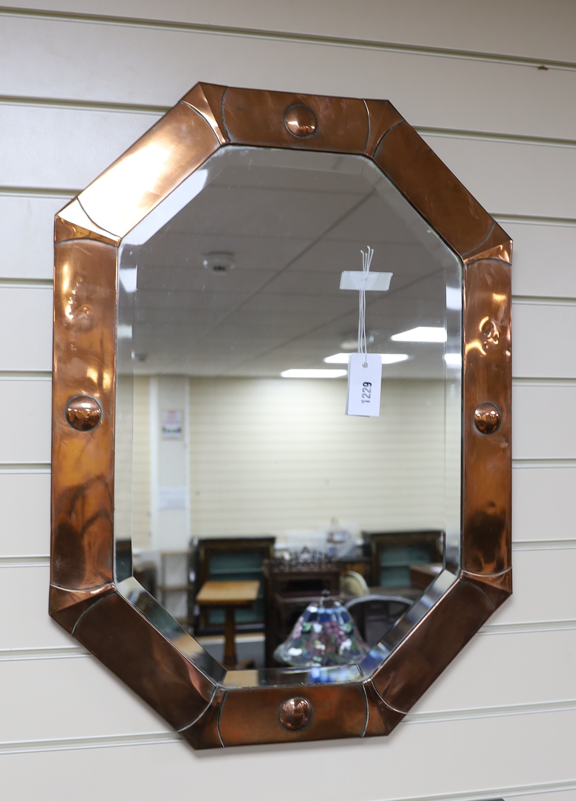 An Arts and Crafts octagonal copper wall mirror width 54cm, height 73cm